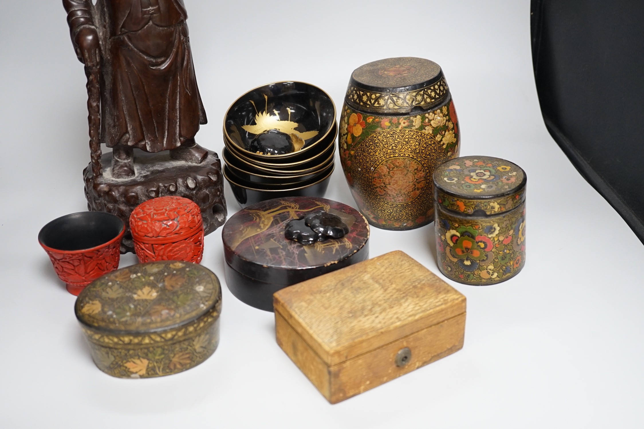 A Japanese red lacquer natsume, 7cm high, and matching tea cup Together with Mixed decorative Oriental and Indian lacquer wares and, a Chinese carved hardwood figure of a sage 39.5cm